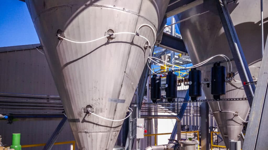 Industrial metal hopper with piping and control