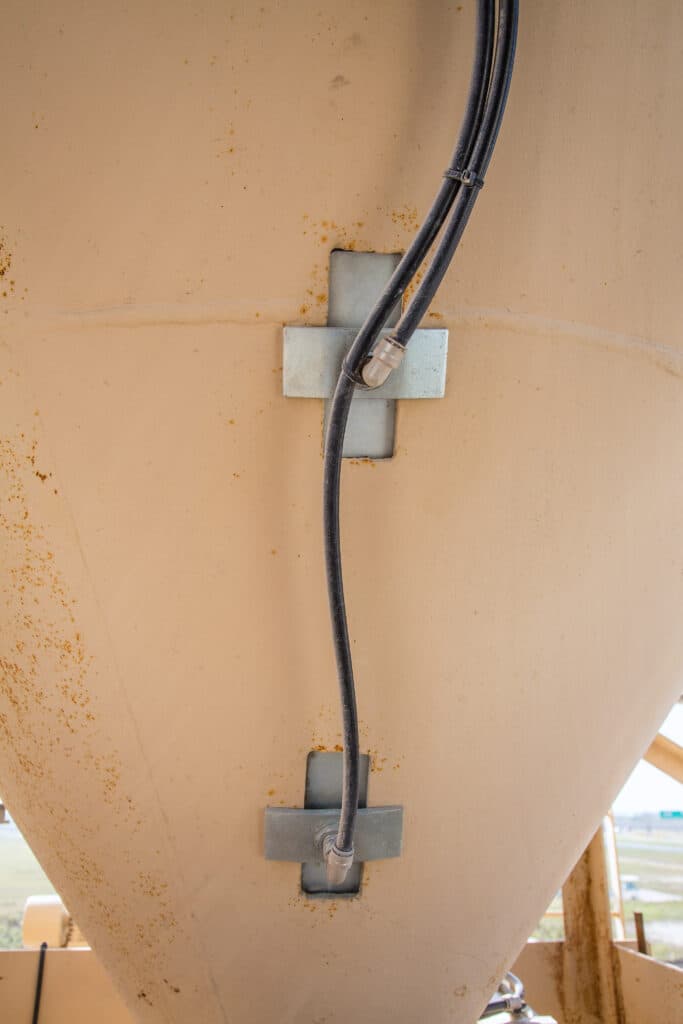 Black cable attached to large metal container